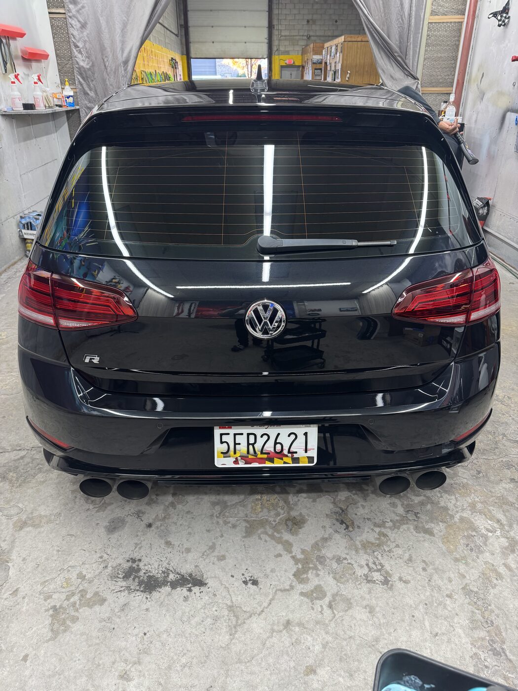 Gloss-black VW Golf R with tinted rear glass, freshly detailed in the Clinton shop